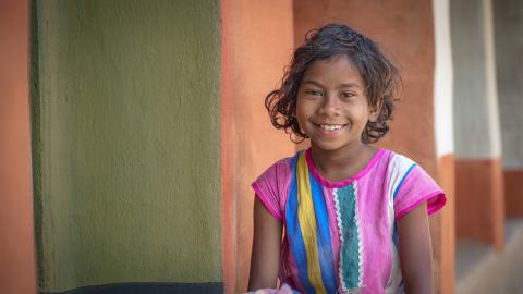 Smiling Young Girl in Colorful Dress